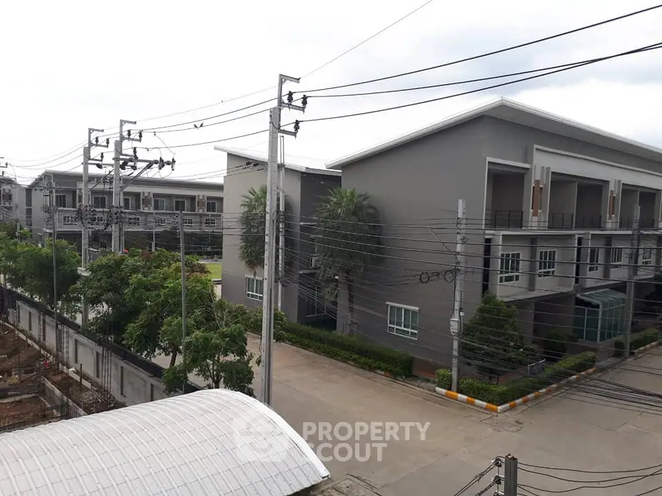 Modern residential building exterior with lush greenery and spacious layout in a serene neighborhood.