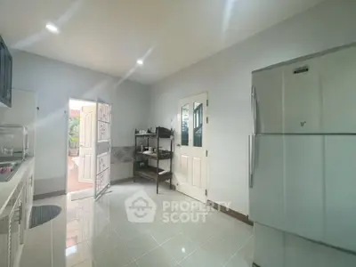 Spacious kitchen with modern appliances and open layout, perfect for culinary enthusiasts.