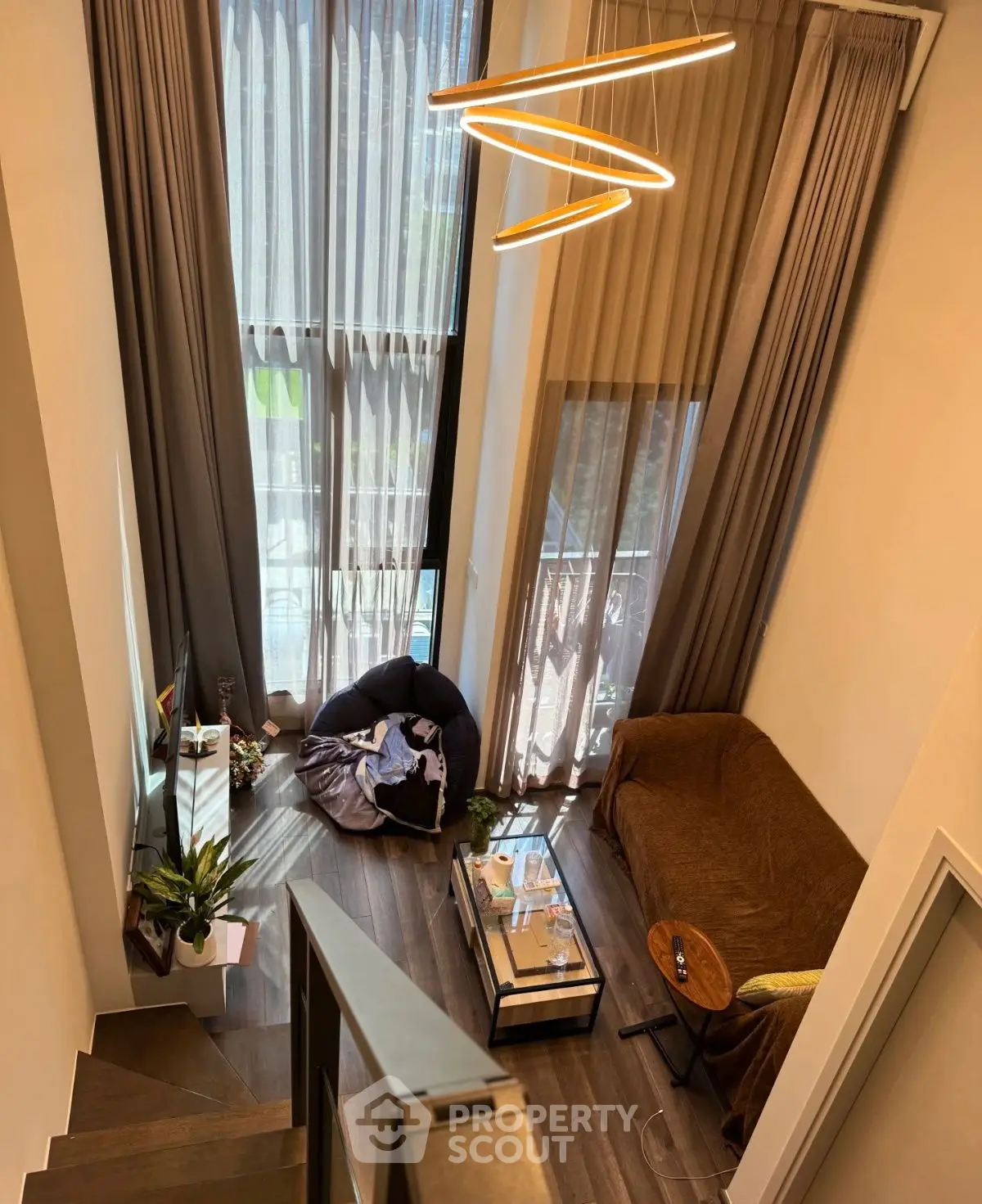 Modern living room with high ceilings and stylish lighting