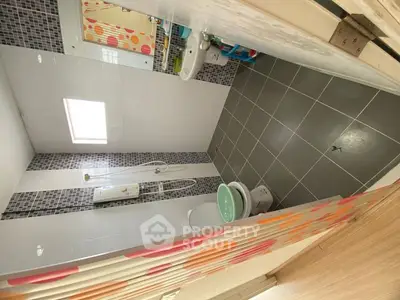 Modern bathroom with sleek tiles and contemporary fixtures.