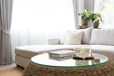 Elegant living room with cozy sofa and stylish coffee table in bright natural light.