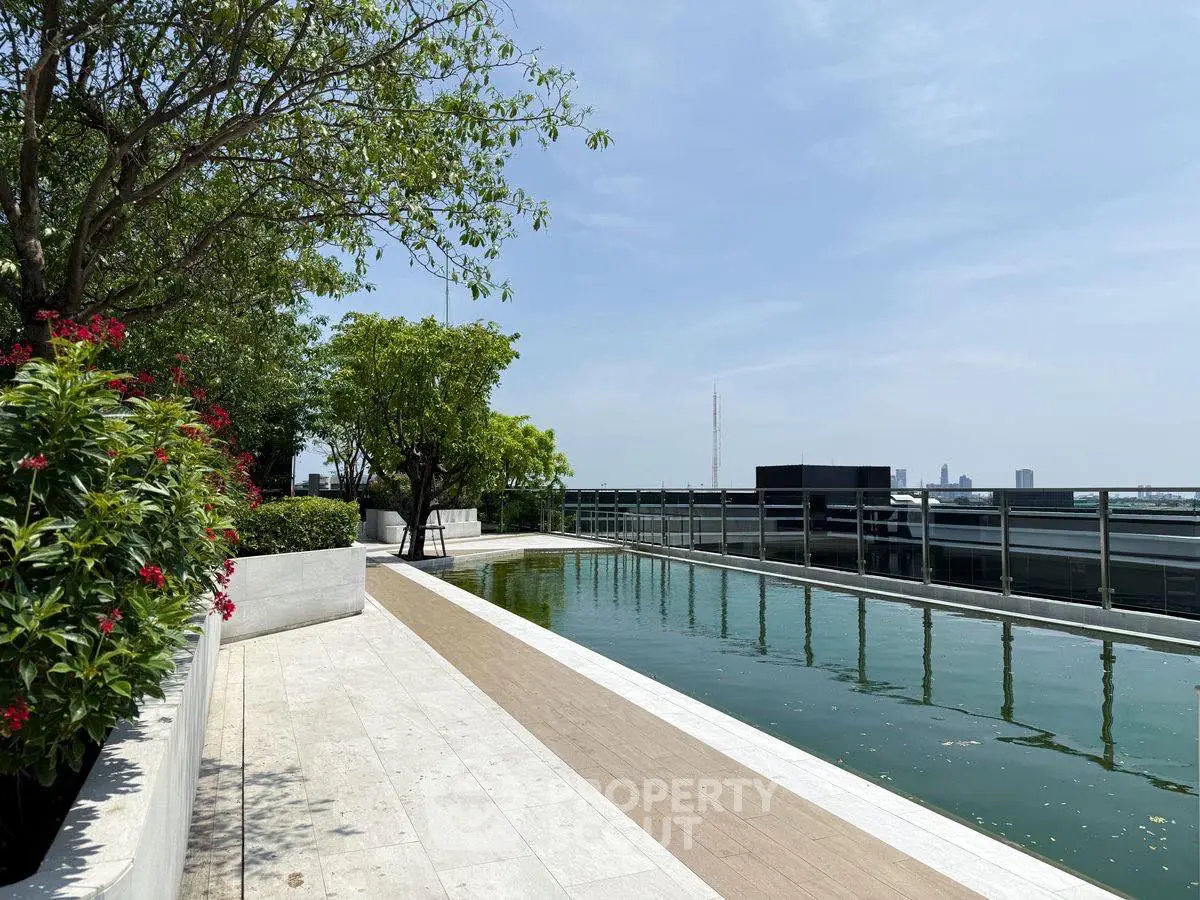 Luxurious rooftop pool with stunning city skyline views and lush greenery.