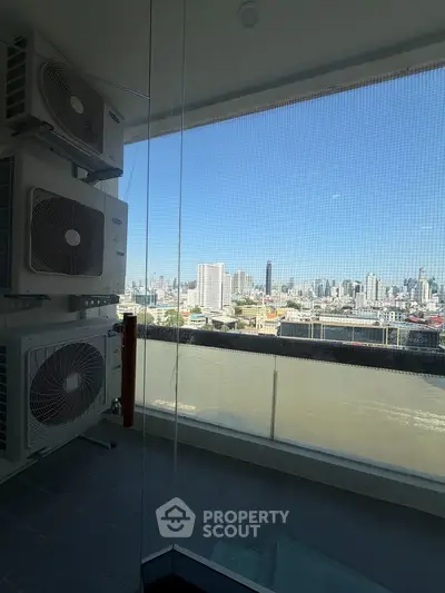 Stunning cityscape view from a modern balcony with air conditioning units.