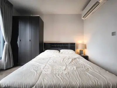 Modern bedroom with cozy double bed and sleek wardrobe, featuring soft lighting and air conditioning.