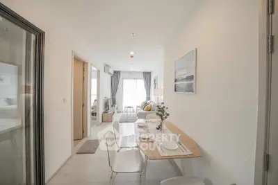 Modern open-plan living and dining area with natural light and stylish decor.