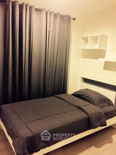 Cozy bedroom with single bed and dark curtains, perfect for a minimalist lifestyle.