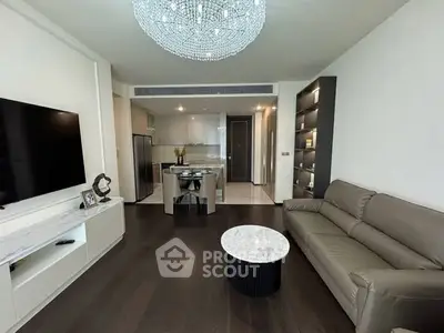 Modern living room with elegant chandelier and open kitchen layout