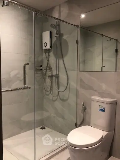 Modern bathroom with glass shower enclosure and sleek fixtures