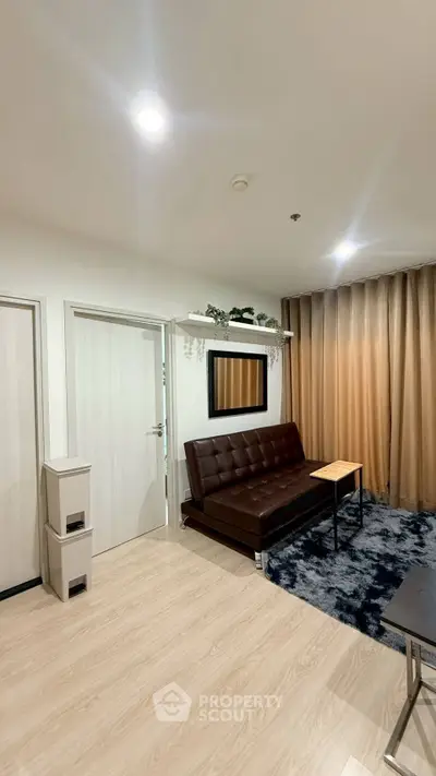 Modern living room with sleek brown sofa and stylish decor in a cozy apartment setting.