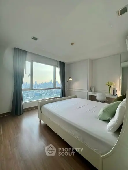Spacious bedroom with stunning city view and modern decor