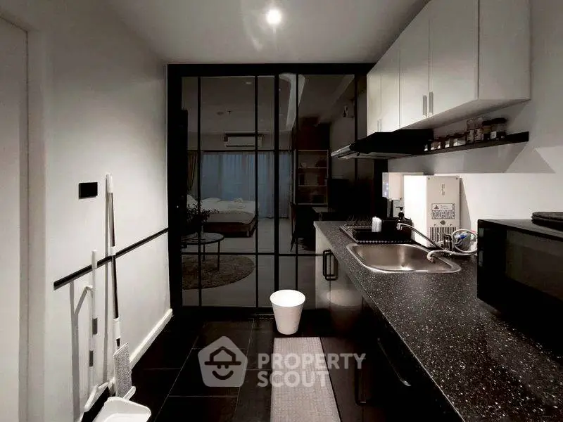 Modern kitchen with sleek black countertops and open layout design