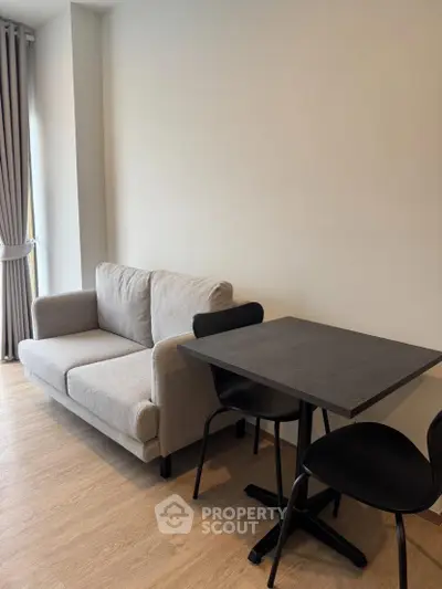 Modern living room with cozy sofa and dining table, perfect for urban living.