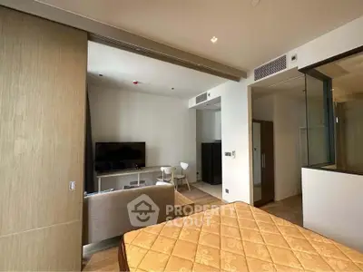 Modern studio apartment with stylish interior and open layout, featuring a cozy living area and sleek design.