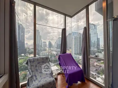 Stunning corner unit with panoramic city views from floor-to-ceiling windows.
