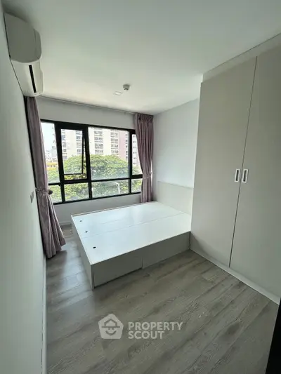 Modern bedroom with built-in storage and large window view