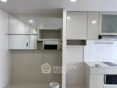 Modern kitchen with sleek cabinetry and built-in appliances in a contemporary apartment.