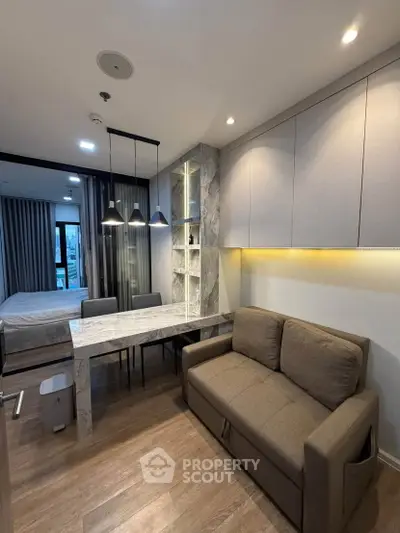 Modern studio apartment with stylish living area and cozy bedroom
