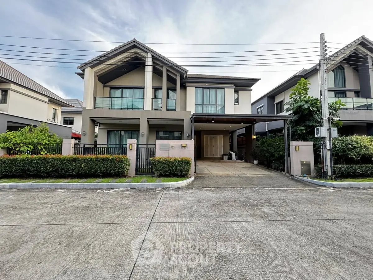 Modern two-story house with spacious driveway and lush greenery