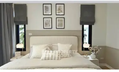 Elegant bedroom with stylish decor and cozy ambiance, featuring framed art and soft lighting.
