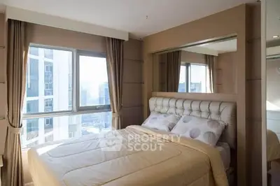 Luxurious bedroom with city view and elegant decor in modern apartment.