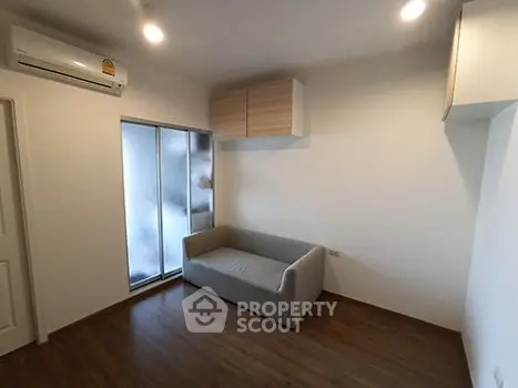 Modern minimalist living room with sleek sofa and wooden flooring