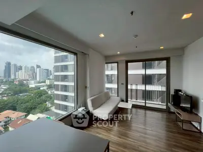 Modern living room with large windows and city view in high-rise apartment