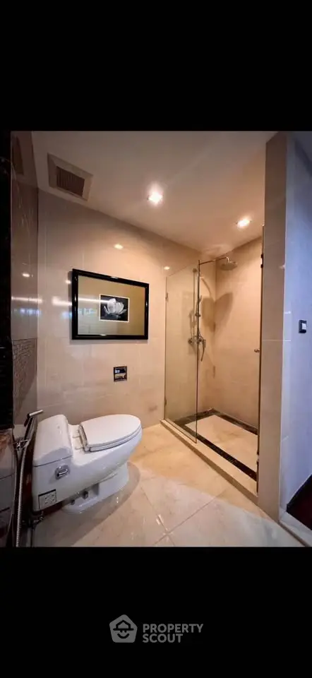 Luxurious modern bathroom with glass shower and elegant fixtures