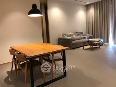 Modern living room with stylish dining area and cozy sofa, perfect for contemporary living.