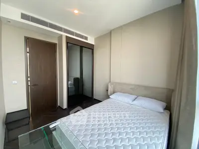 Modern bedroom with minimalist design and large window for natural light