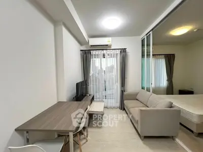 Modern living room with sofa, TV, and dining table in a bright apartment