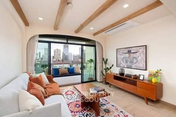 Stylish living room with city view, modern decor, and spacious balcony access.