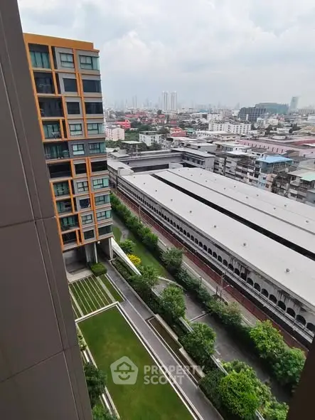 High-rise building with cityscape view and lush green courtyard
