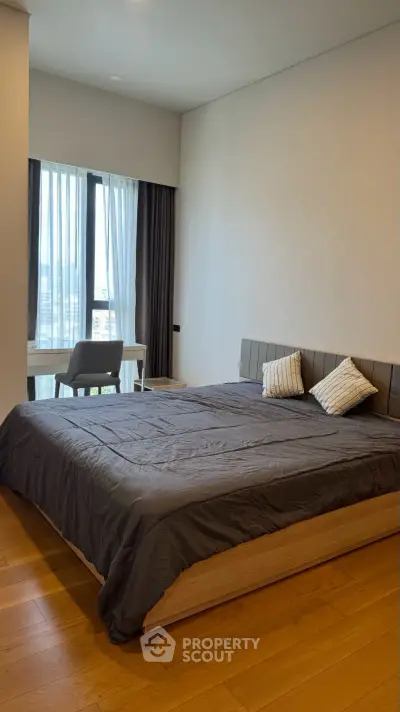 Modern bedroom with large window and stylish decor