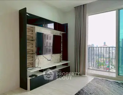 Modern living room with city view and sleek entertainment unit.