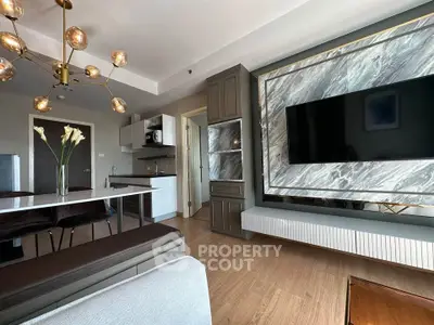 Modern living room with stylish decor, marble accent wall, and elegant lighting in a contemporary apartment.