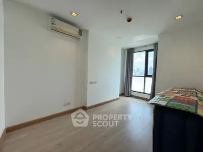 Spacious unfurnished room with large window and city view, perfect for customization.