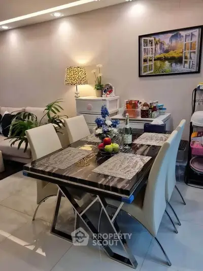 Elegant dining area with modern table and chairs, stylish decor, and ambient lighting in a cozy living space.