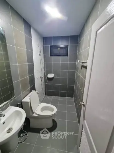 Modern bathroom with sleek gray tiles and contemporary fixtures