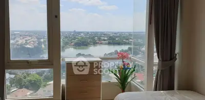 Stunning bedroom with panoramic city and lake view, featuring large windows and elegant decor.