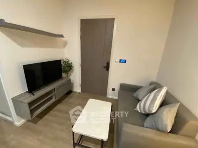 Cozy living room with modern decor and compact furniture