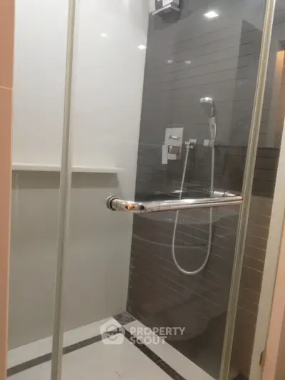 Modern bathroom with sleek glass shower enclosure and contemporary fixtures.