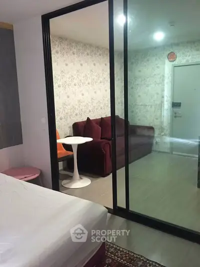 Modern studio apartment with sliding glass doors and cozy living area.