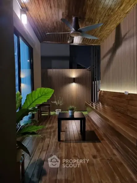 Stylish wooden balcony with ceiling fan and modern lighting