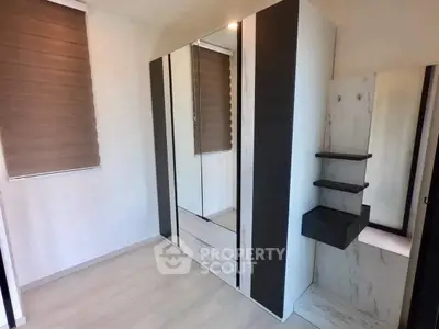 Modern bedroom with sleek wardrobe and stylish window blinds