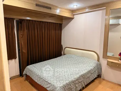 Cozy bedroom with wooden accents and a comfortable bed, perfect for relaxation.