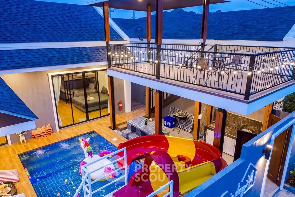Luxurious villa with private pool and slide, spacious balcony, and modern design.