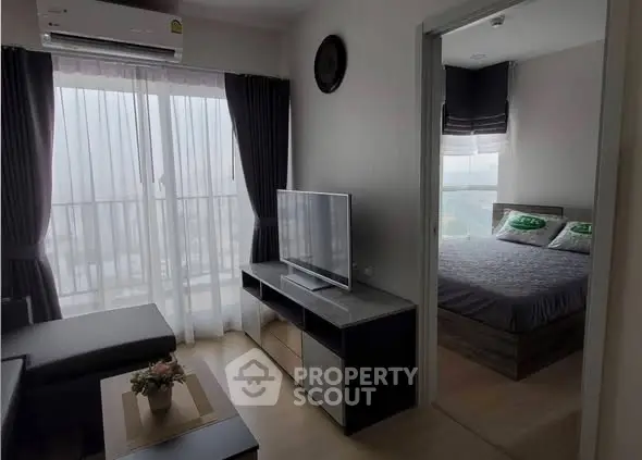 Modern apartment with cozy living room and bedroom, featuring large windows and stylish decor.