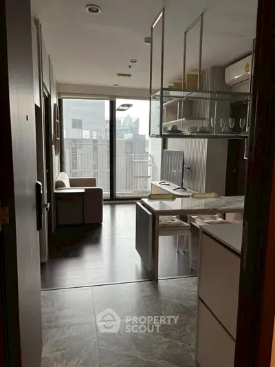 Modern apartment with open layout, stylish furnishings, and large windows offering city views.