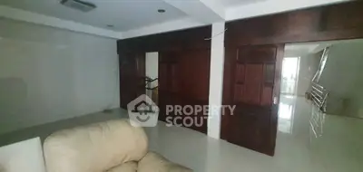 Spacious living room with modern design and elegant wooden accents