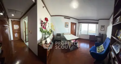 Spacious study room with elegant wooden flooring and large window offering natural light.